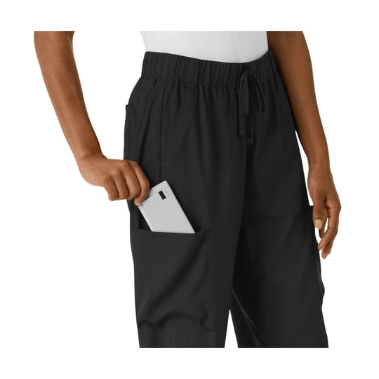 Black wide-leg cargo pants with elastic waistband, drawstring, and side pocket, shown on a model