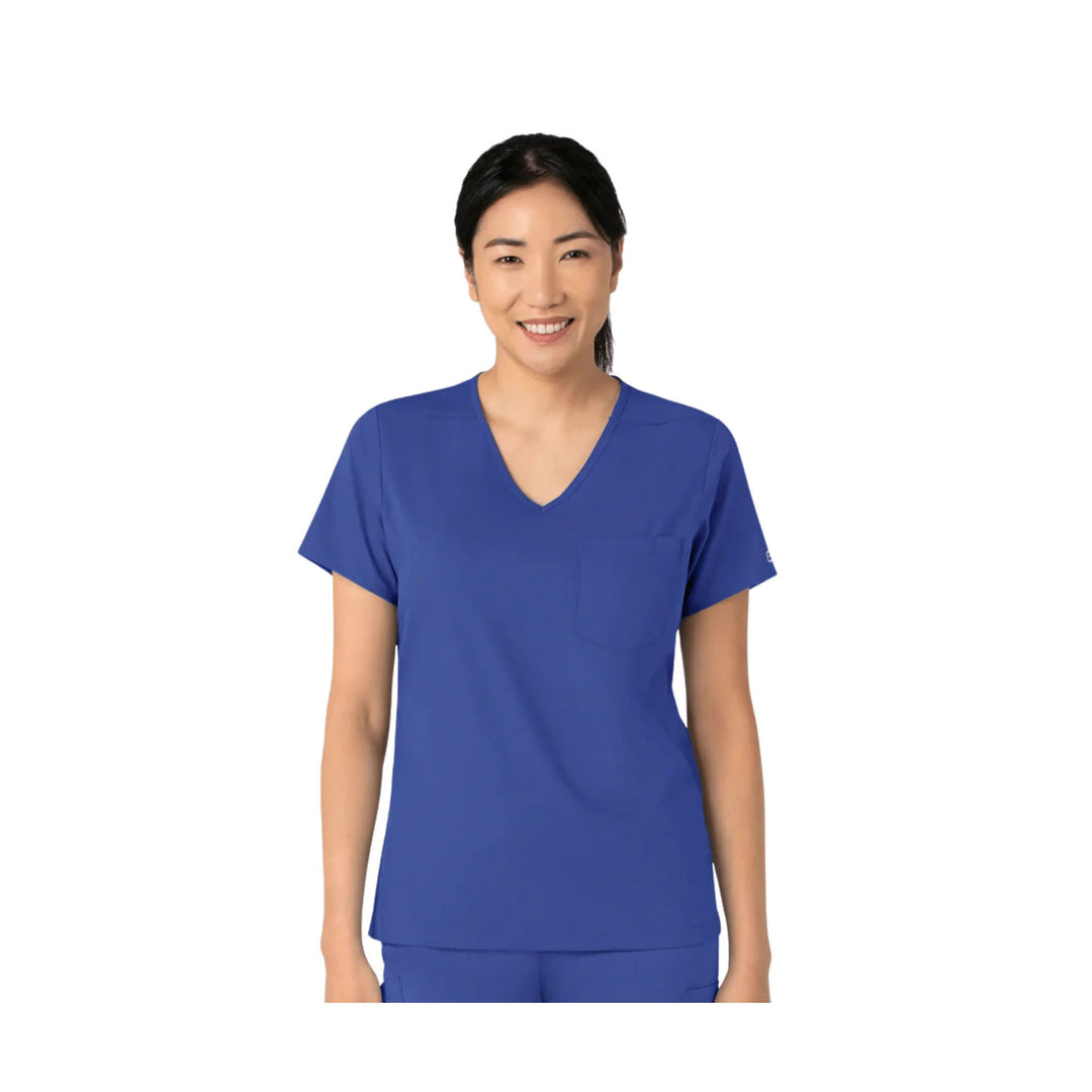 Woman wearing a blue V-neck scrub top with short sleeves and a chest pocket