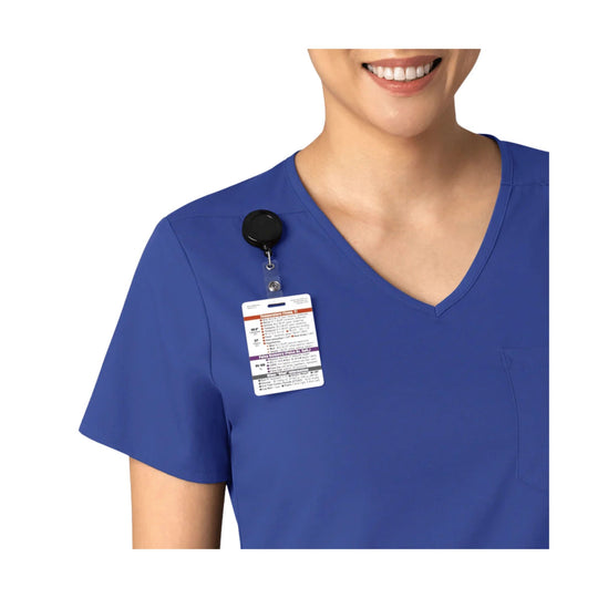 Blue V-neck scrub top with short sleeves and an ID badge clipped at the chest