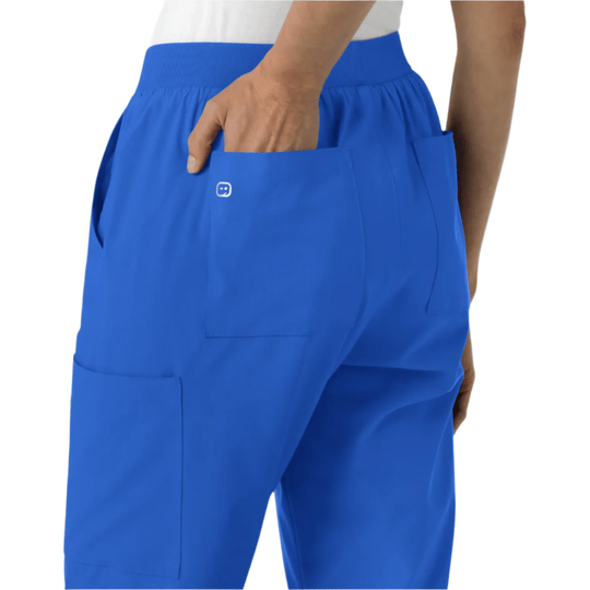 Blue scrub pants with an elastic waist, cargo pockets, and a hand in the back pocket