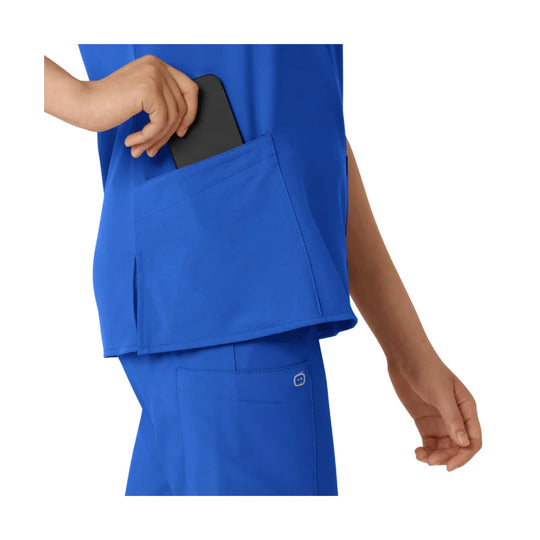Blue scrub top with a side pocket holding a phone