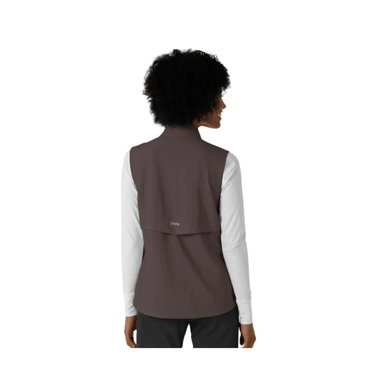 Brown sleeveless scrub vest layered over a white long-sleeve top, shown from the back