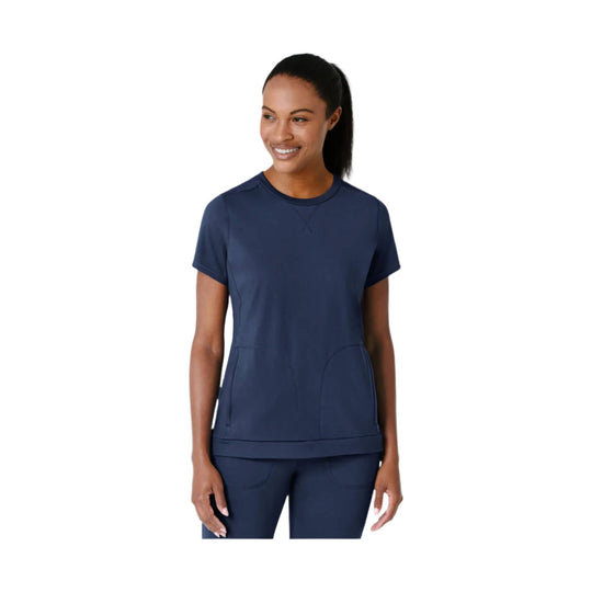 Navy short-sleeve athletic top with curved seam details and matching leggings