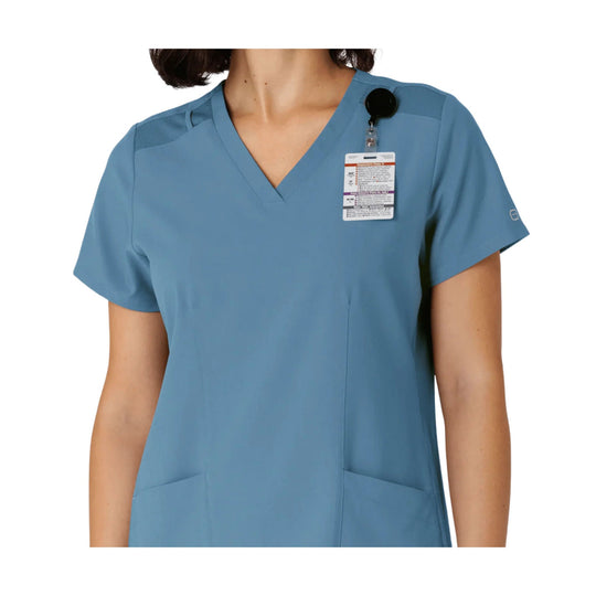 Blue V-neck scrub top with short sleeves and chest tag