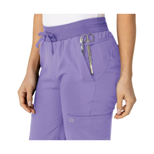 Lavender scrub pants with elastic waistband, drawstring tie, and side cargo pocket with scissor loop
