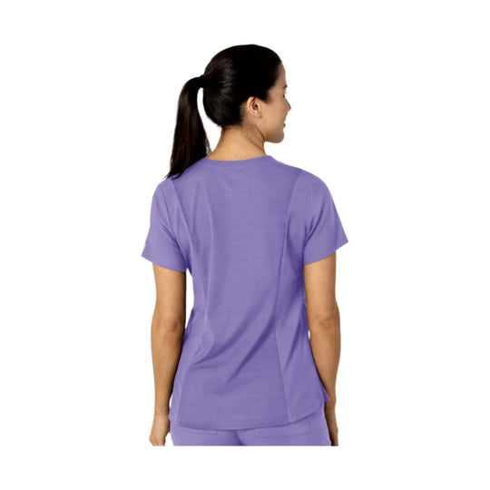 Lavender short-sleeve scrub top shown from the back on a model
