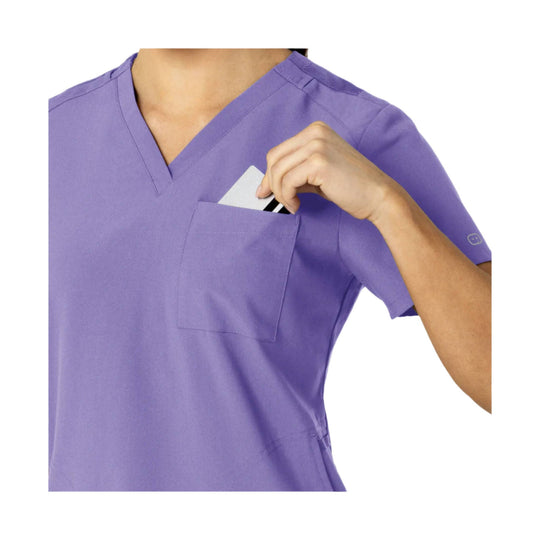 Lavender V-neck scrub top with chest pocket and short sleeves, shown with a hand holding a card in the pocket.
