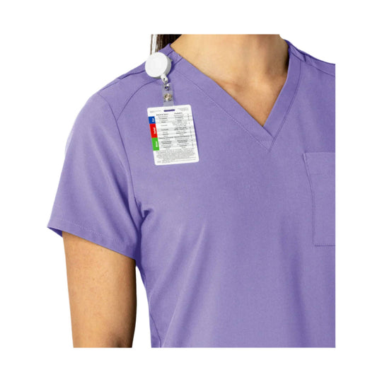 Lavender V-neck scrub top with a chest pocket and hanging size tag