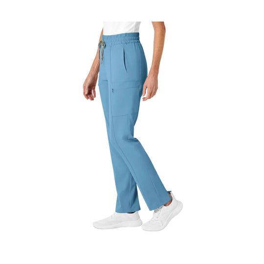 Light blue high-waist scrub pants with straight legs, cargo pockets, and white sneakers