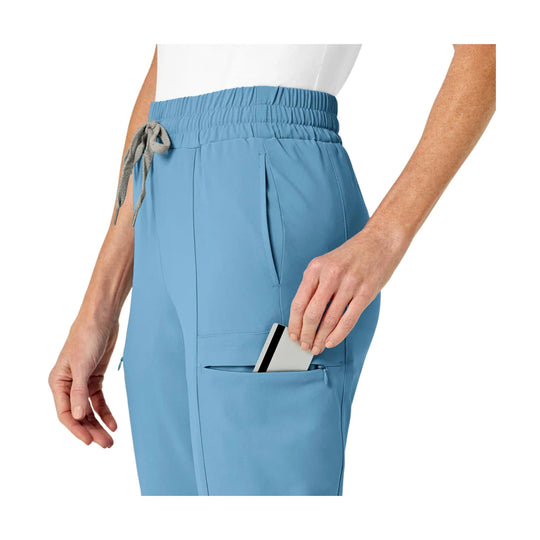 Light blue high-waist scrub pants with an elastic waistband, drawstring, and side pocket