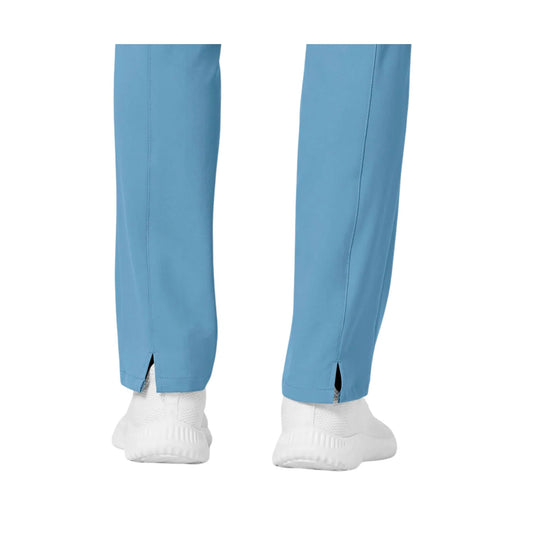 Light blue slim-leg scrub pants with side slits at the hem, shown with white sneakers