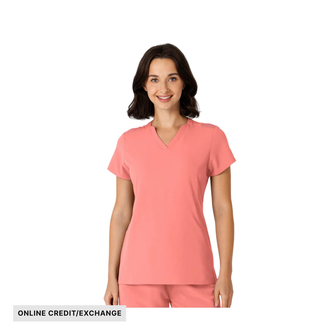 Coral pink V-neck scrub top and pants on a model