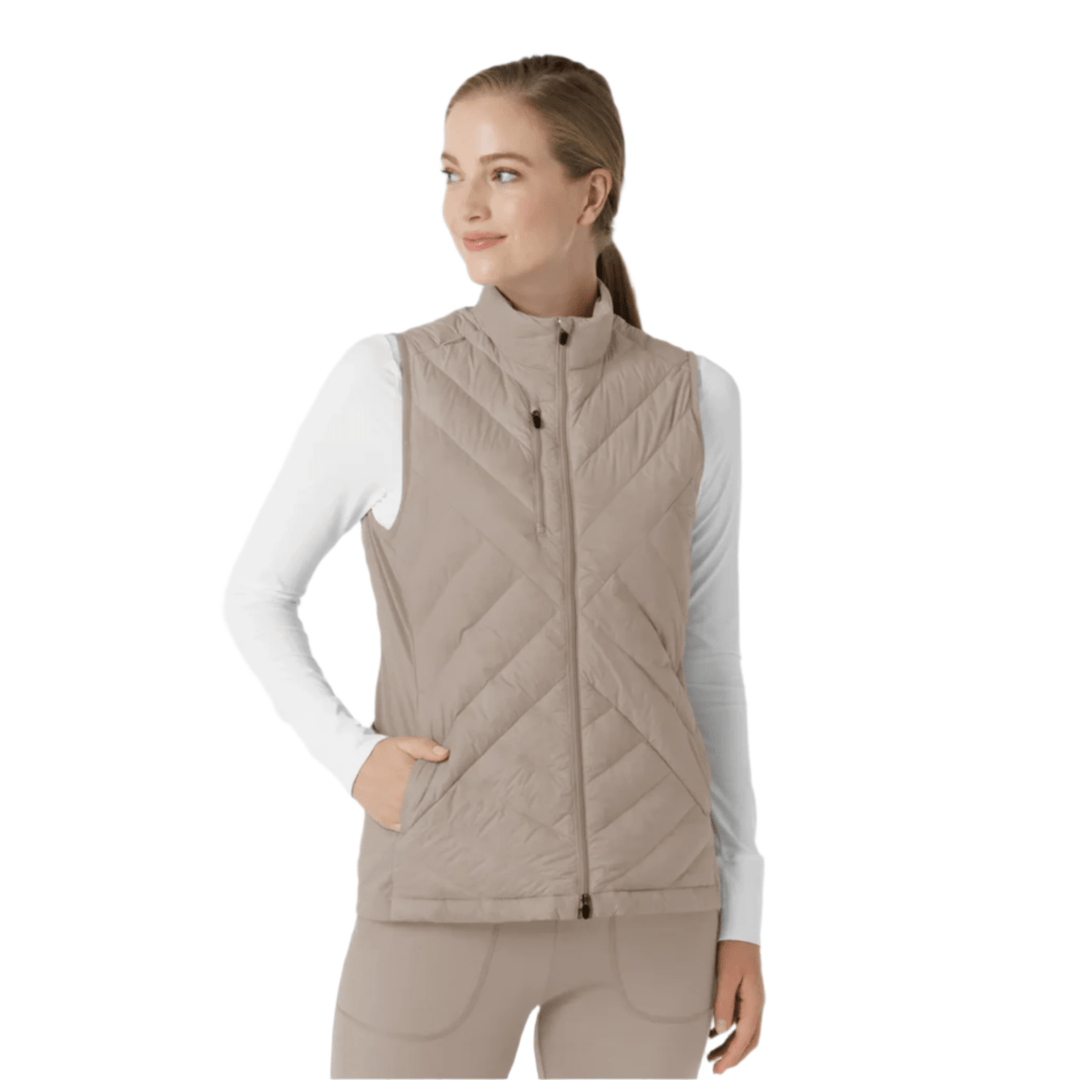 Beige quilted zip-front vest worn over a white long-sleeve top