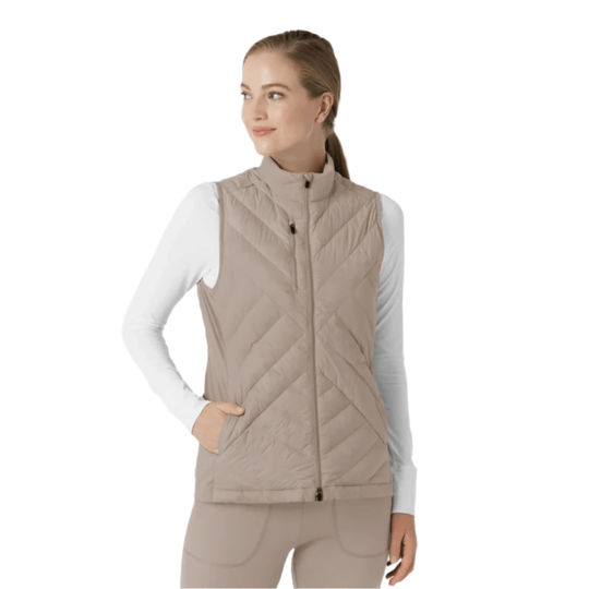 Beige quilted zip-front vest worn over a white long-sleeve top