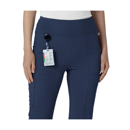 Navy women’s cargo scrub pants with a high waistband, flared legs, and a hanging product tag