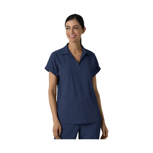 Navy short-sleeve V-neck scrub top with matching pants on a model