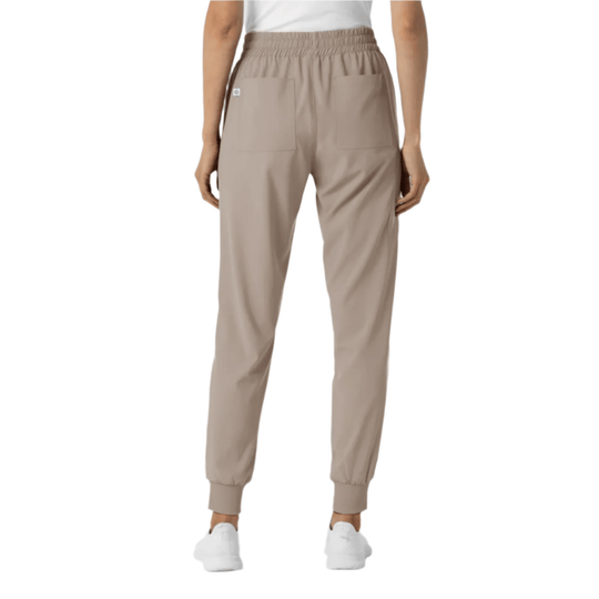 Beige jogger scrub pants with elastic waist, front pockets, and ribbed ankle cuffs