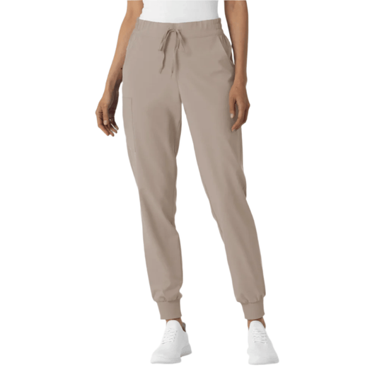 Beige jogger scrub pants with drawstring waist, side pockets, and ribbed ankle cuffs