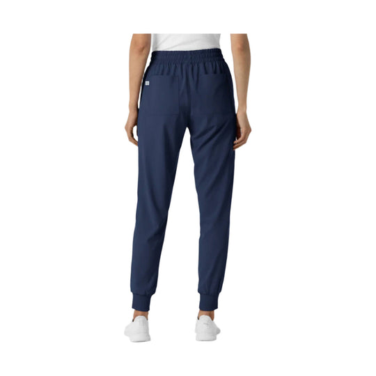 Navy jogger scrub pants with elastic waistband, tapered legs, and ribbed cuffs, shown from the back