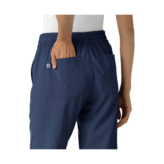 Navy scrub jogger pants shown from the back with elastic waistband and large patch pockets