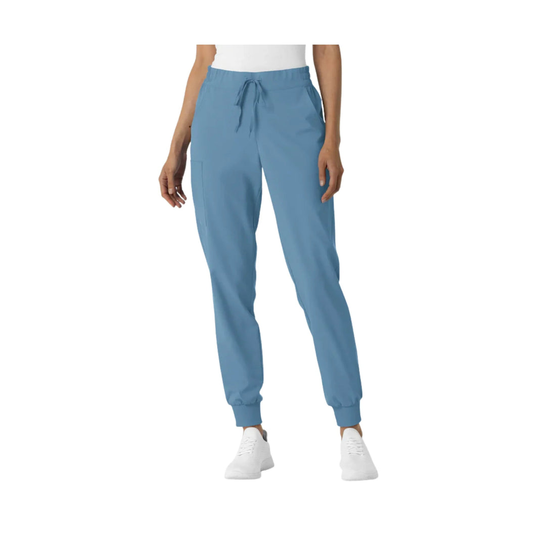 Blue jogger scrub pants with drawstring waist and cuffed ankles on a model