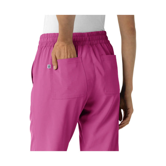Pink jogger scrub pants shown from the back with an elastic waistband and patch pockets
