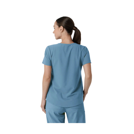 Light blue scrub top shown from the back on a model