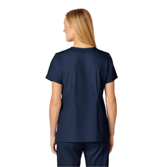 Navy scrub top shown from the back on a model