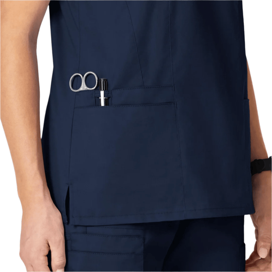 Navy scrub top with chest pocket holding scissors and a pen
