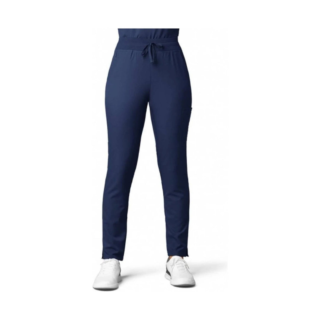 Navy straight-leg scrub pants with an elastic waist and drawstring, shown on a model with white sneakers