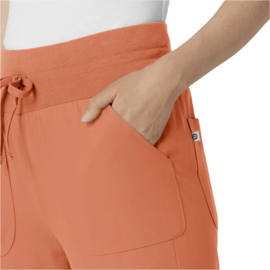 Coral scrub jogger pants with a drawstring waistband and large side pockets
