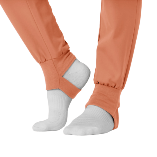 Terracotta jogger scrub pants with elastic cuffs over white socks