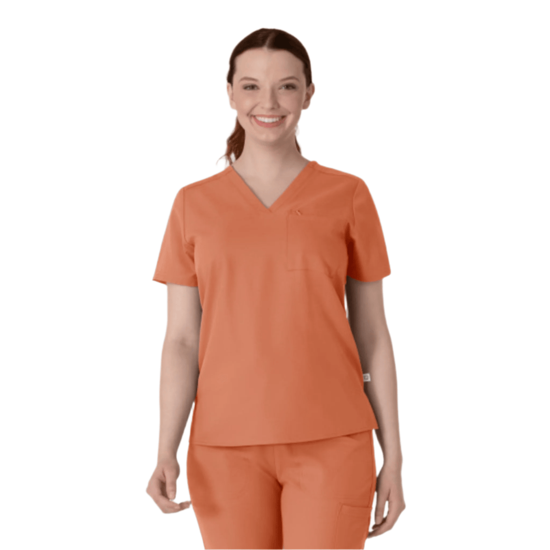 Coral V-neck scrub top with chest pocket, shown with matching scrub pants