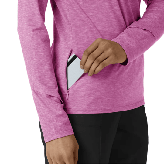 Pink long-sleeve quarter-zip top with a side pocket open