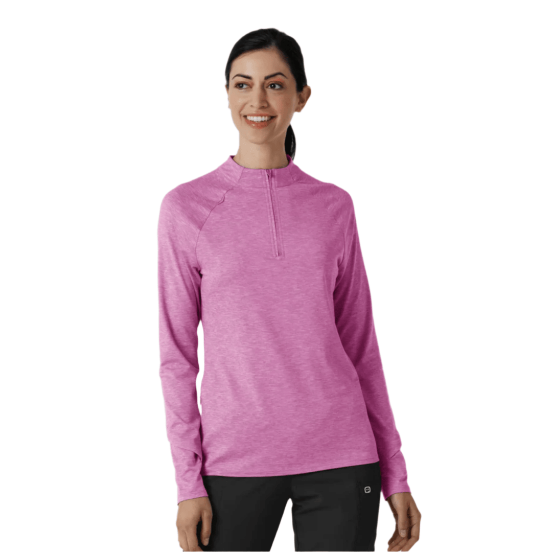 Woman wearing a pink long-sleeve quarter-zip top with a heathered finish and black pants