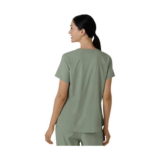 Back view of a sage green short-sleeve scrub top with a relaxed fit