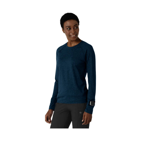 Long-sleeve navy heather crewneck top worn with black pants