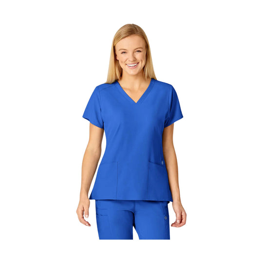 Blue V-neck scrub top with short sleeves and front patch pockets on a model