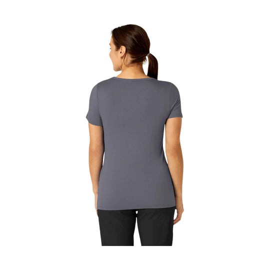 Gray short-sleeve women’s tee shown from the back on a model with a ponytail