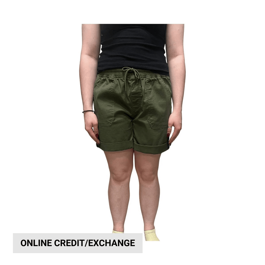 Olive drawstring cargo shorts worn with a black tank top