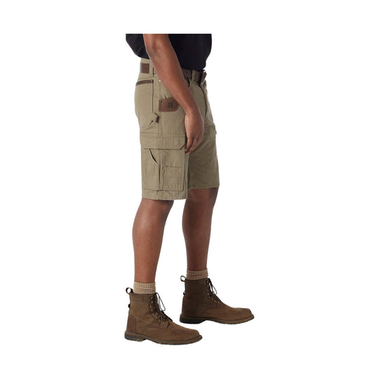 Khaki cargo shorts with side utility pockets, shown on a model with brown boots.