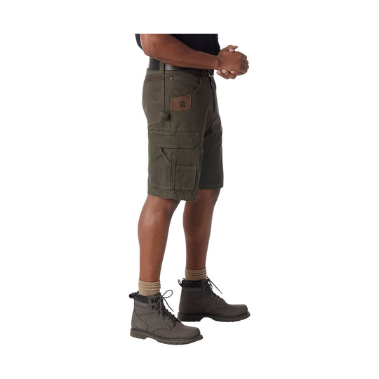 Olive cargo shorts with multiple utility pockets, shown on a model with work boots