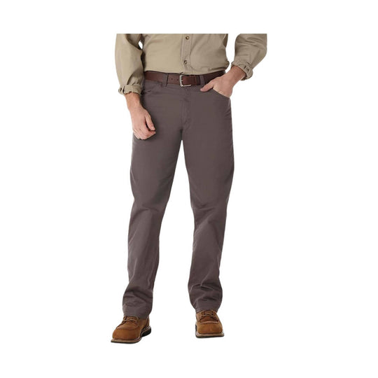 Person wearing gray pants and a beige shirt on a white background