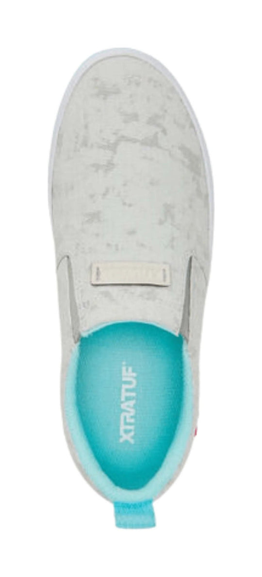 Light gray slip-on deck shoe with a turquoise insole and heel pull tab