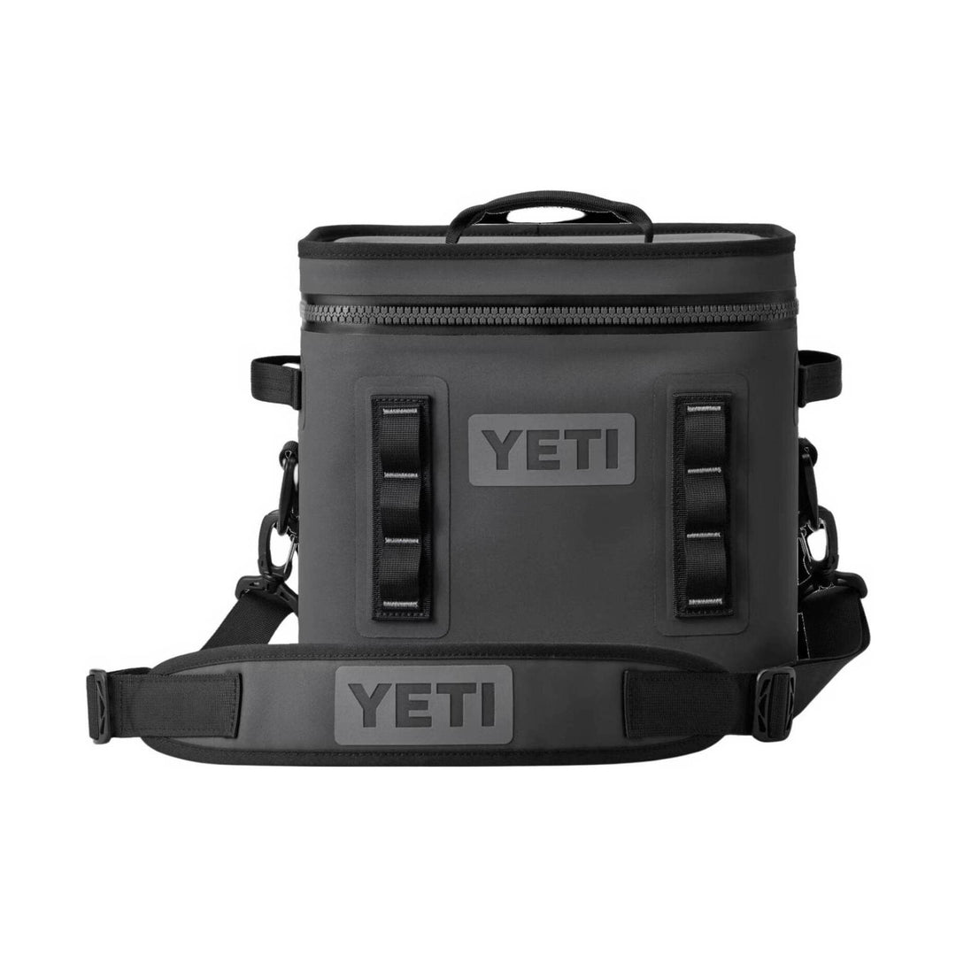 A black YETI insulated cooler bag with a top handle, front zipper, and adjustable shoulder strap, shown on a plain white background.