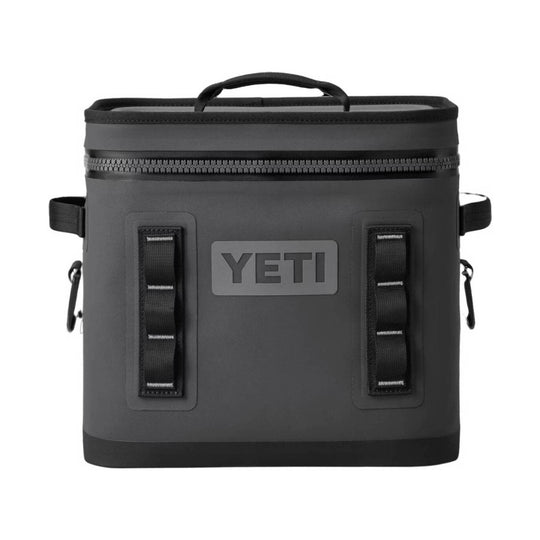 A YETI hard-sided cooler bag in dark gray, featuring a top carry handle, a top zipper, two front webbing straps, and a gray YETI logo patch on the front, set against a plain white background.