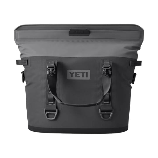 Dark gray soft-sided cooler bag with front straps and YETI logo