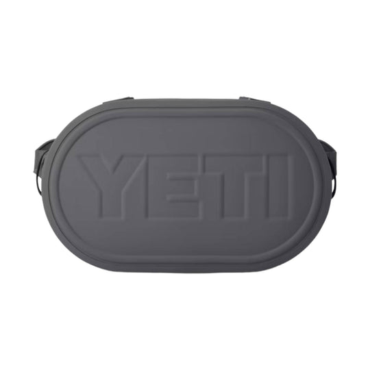 Dark gray oval soft cooler with embossed YETI logo and side handles