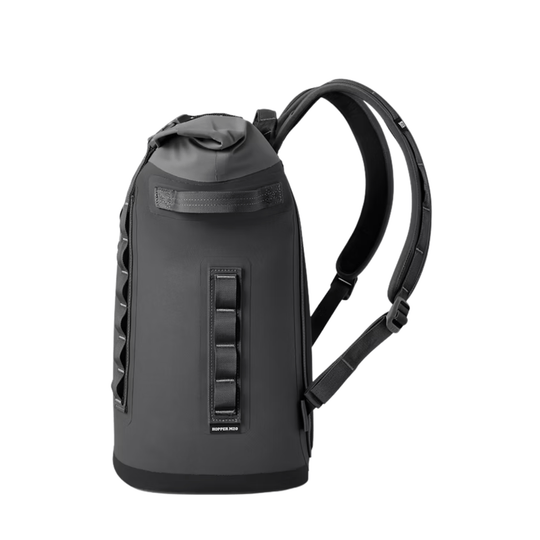 Dark gray backpack-style soft cooler with padded straps, side handle, and front webbing panel.