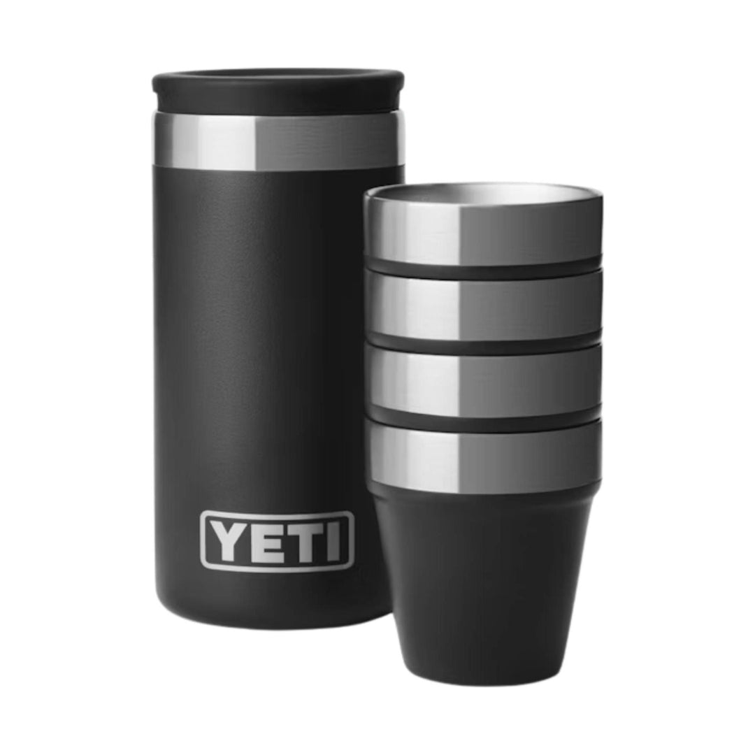Black travel tumbler with stainless steel band and two stacked stainless cups beside it